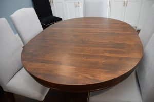 Handstone Round Table – Wormy Maple, Heritage Finish, Nutmeg Stain – 48" + two 12" leaves - Georgetown Camel Back Chairs (Silky 91)